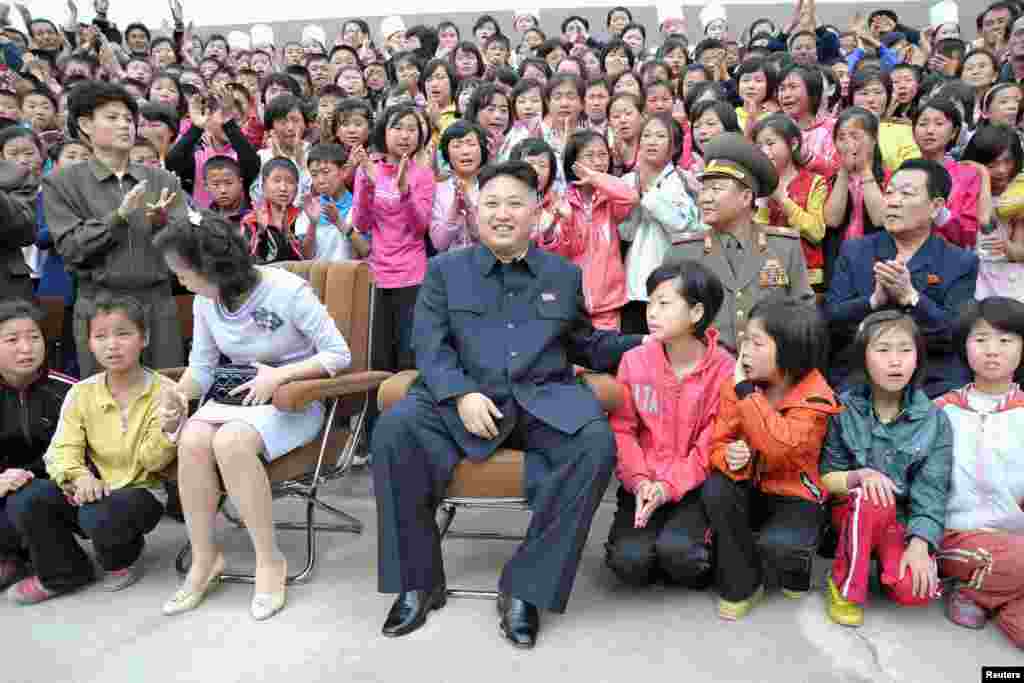 North Korean leader Kim Jong Un and wife Ri Sol Ju sit during a visit to the Pyongyang Myohyangsan Children&#39;s Camp, situated at the foot of Mt. Myohyang in North Phyongan Province. (Reuters/North Korea&#39;s Korean Central News Agency)