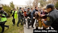 Azerbaijani police haul away protesters in central Baku on January 26.