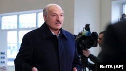Belarusian President Alyaksandr Lukashenka speaks to journalists as he visits a paper factory in Dobrush, Belarus, on February 4.