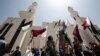 Palestinians attend a rally in support of Qatar, at the Qatari-funded housing project in the southern Gaza Strip city of Khan Yunis on June 9, 2017.