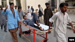 A boy who was injured in a roadside bomb blast is brought to a local hospital in Quetta, Balochistan Province on August 11. 