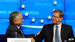 Belgium -- EU Commissioner for Enlargement Stefan Fuele (R) and Armenian Foreign Minister Edward Nalbandian shake hands during a press conference at the EU Headquarters in Brussels, December 9, 2013