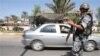 Iraq -- An Iraqi policeman stands guard at a checkpoint in central Baghdad, 13Sep2007