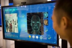 Посетитель пробует технологию распознавания лиц на технологической выставке в Пекине, 26 апреля 2018 года.