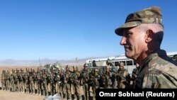 U.S. Army General John Nicholson speaks with Afghan police special forces after they took part in a military exercise in November.