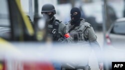 Belgium -- Police and special forces members patrol at the site of a shooting in Brussels, on March 15, 2016. 