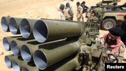 A rebel fighter mans a Grad rocket launcher in the front line along the western entrance of Ajdabiyah