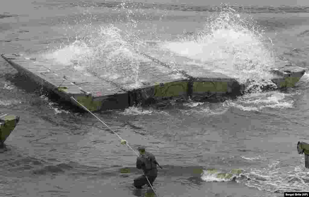 Unfolding a section of the pontoon bridge. &nbsp;