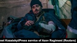 An injured Ukrainian soldier sits in a field hospital inside a bunker at the Azovstal Iron and Steel Works in Mariupol on May 10.