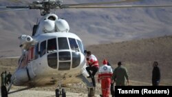 Rescue workers search for a plane that crashed in a mountainous area of central Iran on February 18.