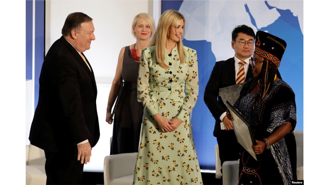 U.S. Secretary of State Mike Pompeo (left) and White House senior adviser Ivanka Trump (center) greet Francisca Awah Mbuli, a survivor of human trafficking from Cameroon, during an event to unveil the 2018 Trafficking in Persons report at the State Department in Washington on June 28.