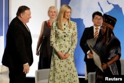 U.S. Secretary of State Mike Pompeo (left) and White House senior adviser Ivanka Trump (center) greet Francisca Awah Mbuli, a survivor of human trafficking from Cameroon, during an event to unveil the 2018 Trafficking in Persons report at the State Department in Washington on June 28.