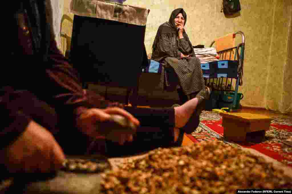 Musalmagomedova watches her daughter crushing apricot stones. Her daughter does not live here but comes to help as much as she can.