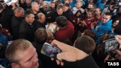 Russian President Vladimir Putin (center) is surrounded by admirers as he attends the Seliger youth camp on August 29.