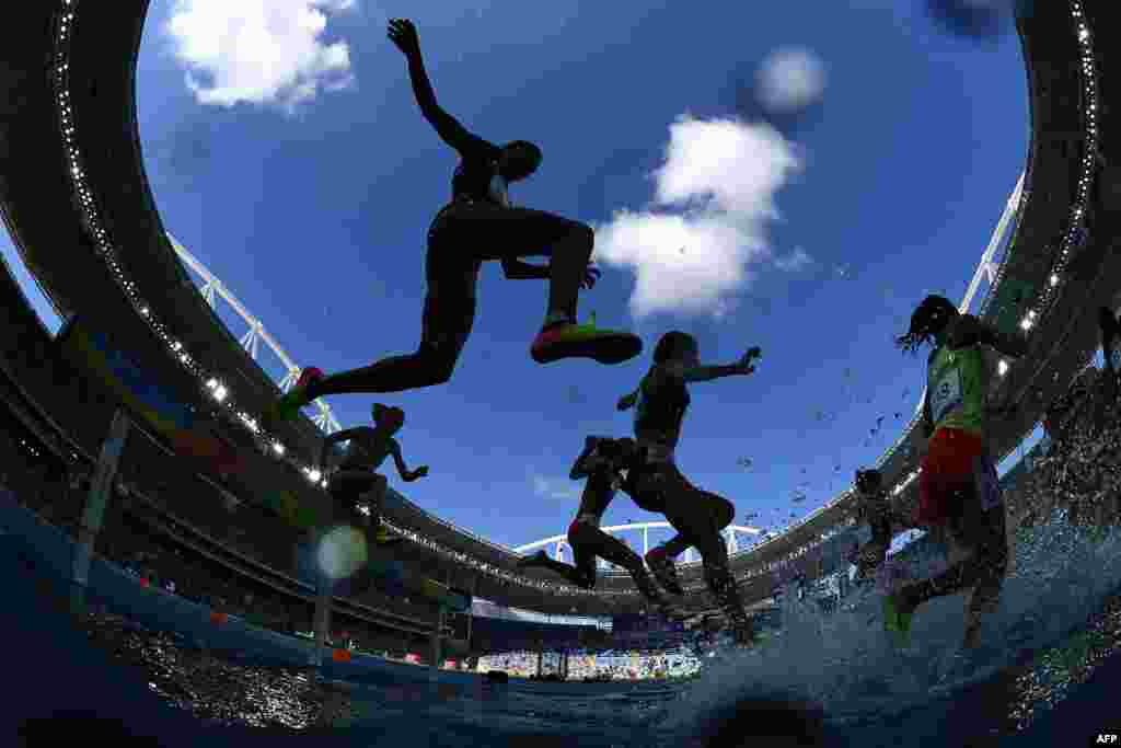 Athletes compete in the women&#39;s 3,000-meter steeplechase first round.