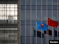 Прапори китаю та компанії China National Petroleum Corp (CNPC) майорять біля штаб-квартири компанії в Пекіні. Украна включила CNPC до списку «спонсорів війни»