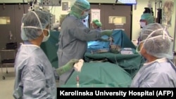 Paolo Macchiarini carrying out the world's first transplant of a synthetic trachea or windpipe on Andemariam Teklesenbet Beyene in Stockholm in 2011. The patient later died in 2014.