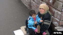 A Roma woman begs in Almaty.