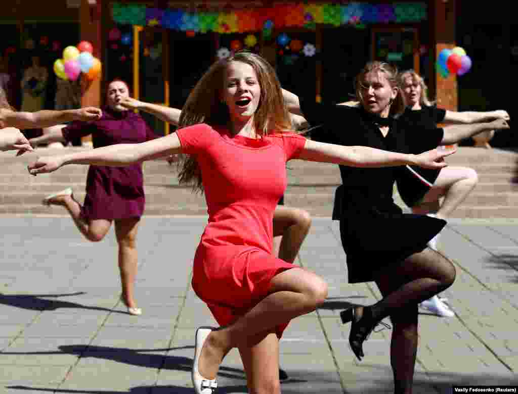 High-school graduates hop through a farewell ceremony at a school in Minsk. Dzmitry Hurnievic, a journalist with RFE/RL&rsquo;s Belarus service, thinks there may be some truth to the Gallup poll findings. 