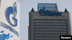 Russia -- A view shows a sign of a petrol station of Gazprom Neft company and the headquarters of the Russian natural gas producer Gazprom in Moscow, February 24, 2015