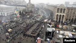 Pro-European-integration protesters spell out the Ukranian word "lustration" on Independence Square in Kyiv on December 19.