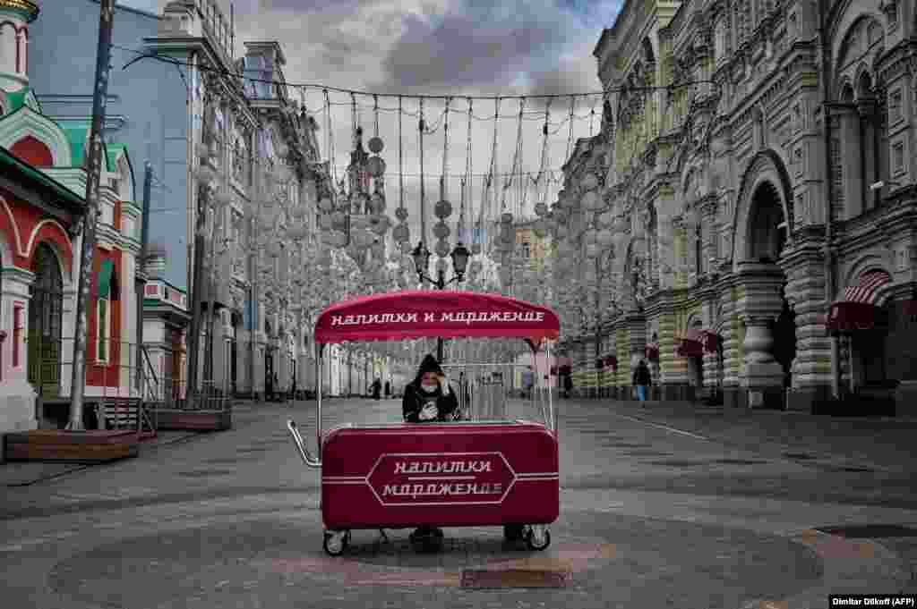 A woman wearing a protective face mask sells ice cream in downtown Moscow on June 4. (AFP/Dimitar Dilkoff)