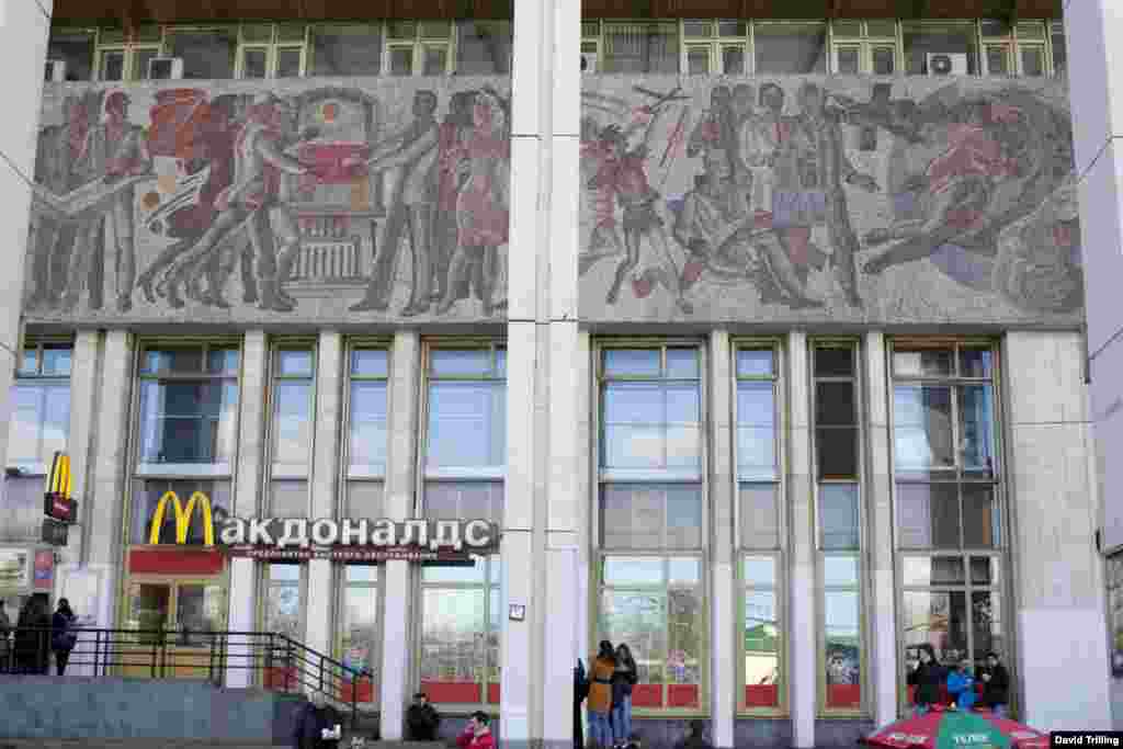 Outside the station, more mosaics sit incongruously above an American fast-food outlet.