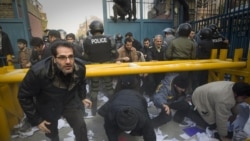 Protesters enter the gate of the British embassy in Tehran, as the police stand by. Nov. 29, 2011