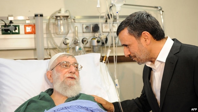 A handout photo provided by the office of Iran's supreme leader Ayatollah Ali Khamenei shows former president Mahmoud Ahmadinejad (R) visiting him at a hospital in Tehran on September 8, 2014, after his prostate opertion.