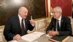 Belarusian President Alyaksandr Lukashenka talks with Austrian President Alexander Van der Bellen during their meeting in Vienna on November 12.