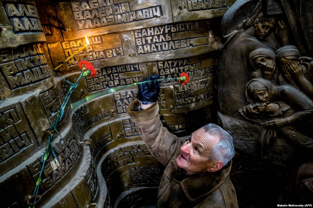 A man lays flowers at a memorial to Soviet soldiers killed during the Soviet war in Afghanistan in Minsk in February 2018.