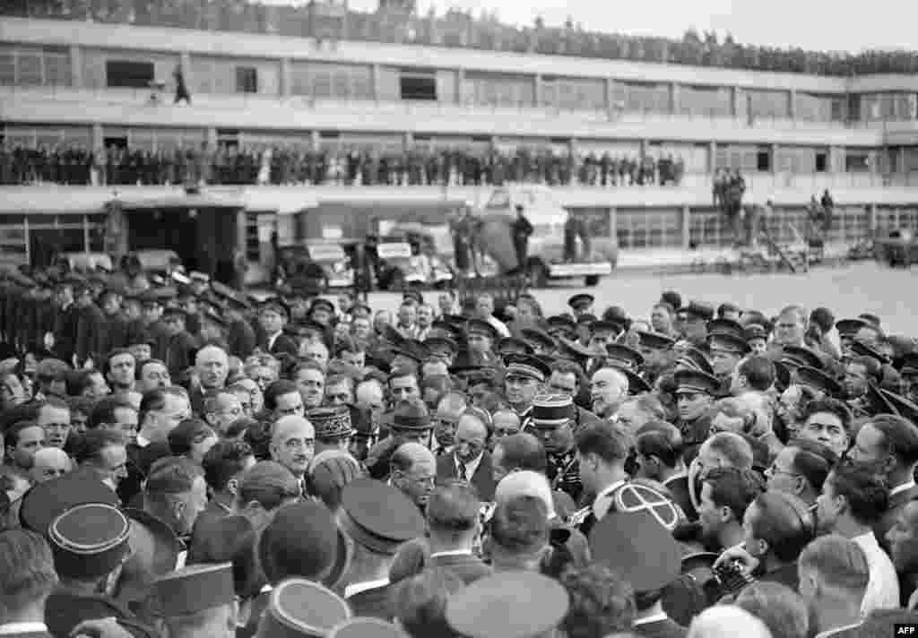 France's Edouard Daladier reads a statement to journalists after returning from Munich on September 30, 1938. Regarding the unexpected acclaim he received  after returning to Paris, Daladier was said by Jean-Paul Sartre to have said, "Ah, the fools."