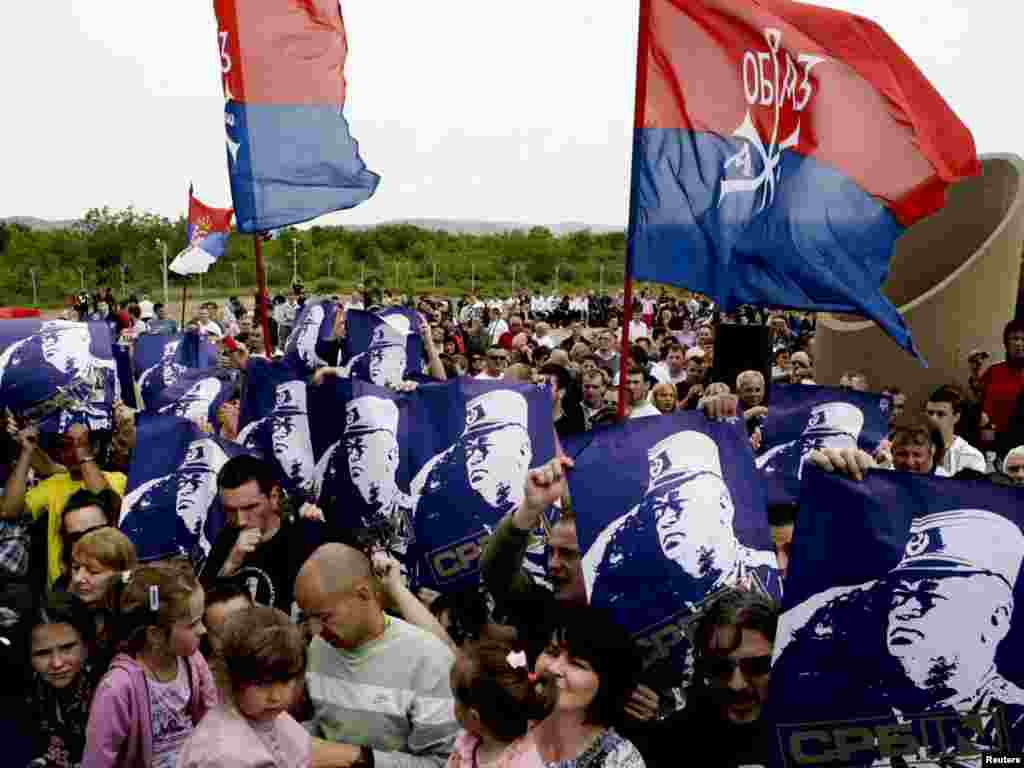 Serbs hold posters of former Bosnian Serb wartime military commander Ratko Mladic at an event to mark the battle anniversary in Gazimestan in 2011.