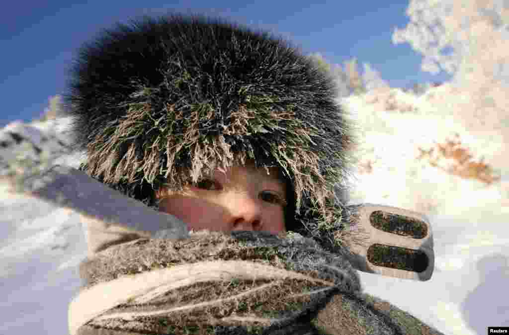 Frost covers the cap and scarf of a Russian child walking on a bank of the Yenisey River in air temperatures of about minus 30 degrees Celsius outside the Siberian city of Krasnoyarsk. (Reuters/Ilya Naymushin)