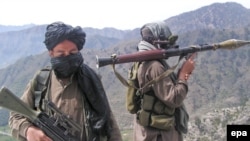 Taliban fighters patrol outside the Swat Valley near Buner district.