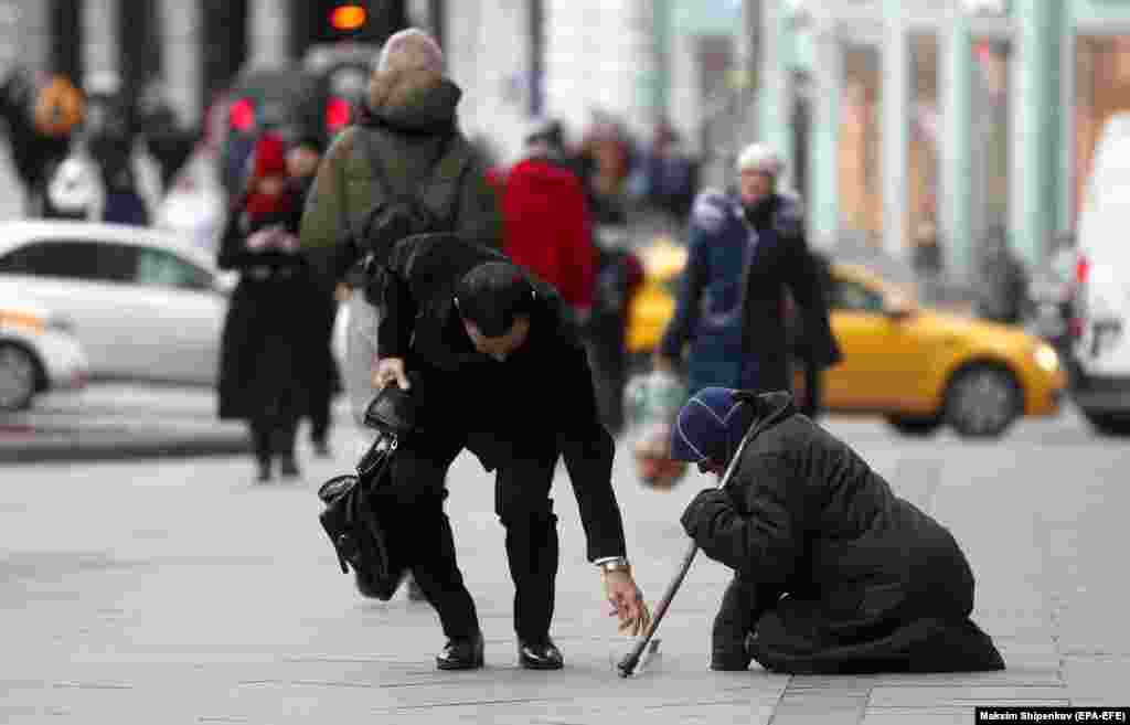 A Russian beggar woman seeks alms on Tverskaya Street in downtown Moscow. (epa-EFE/Maxim Shipenkov)