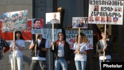 Armenia - Members of the Founding Parliament opposition movement hold up pictures of its arrested leaders during a rally in Yerevan, 17Apr2015.