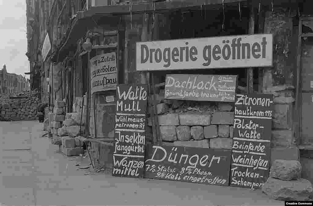 A store in the ruins in late 1945 selling toiletries and beauty products, as well as fertilizer and house paint.