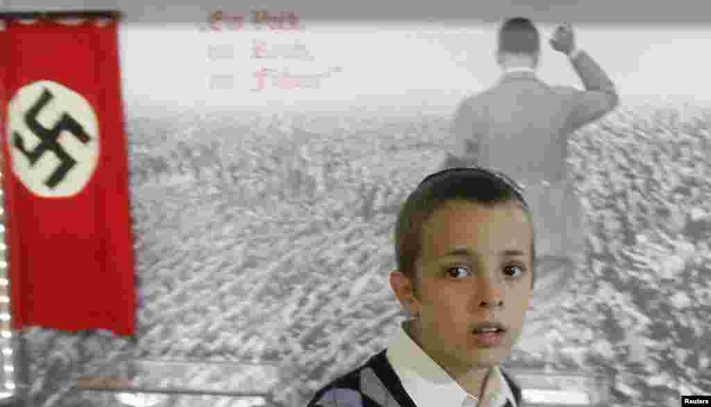 A young visitor looks at a Holocaust exhibition inside the newly opened Jewish Menorah Center in Dnipropetrovsk, Ukraine. (REUTERS/Gleb Garanich)