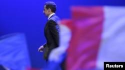 Nicolas Sarkozy leaves the stage after a speech following his reelection defeat in May in a runoff vote against Socialist Francois Hollande.