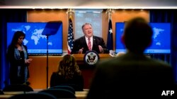 US Secretary of State Mike Pompeo, accompanied by State Department spokeswoman Morgan Ortagus(L) speaks at a news conference at the State Department on April 29, 2020, in Washington,DC. (Photo by Andrew Harnik / POOL / AFP)