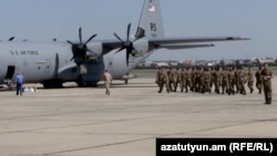 Armenia - Armenian troops board a U.S. military transport plane bound for Kosovo at Yerevan airport, 6Jul2012.