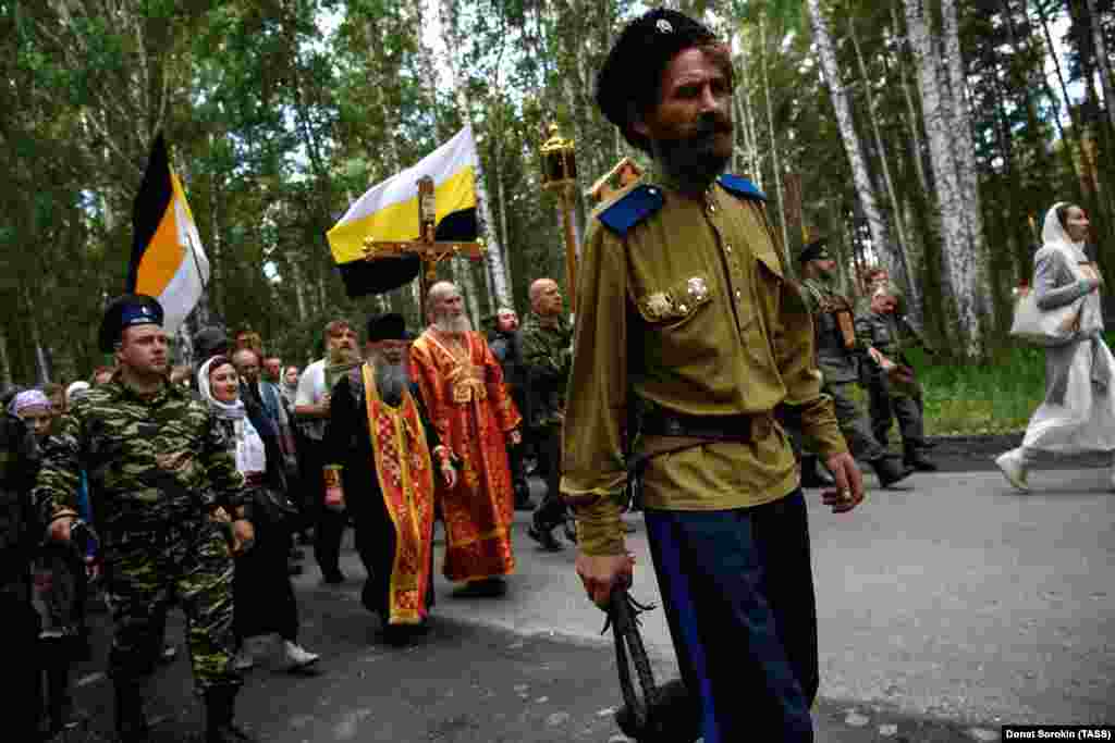 Bullwhip in hand, a Cossack walks ahead of the procession. The marchers followed the route taken by the Bolsheviks as they drove the bodies to a forest north of Yekaterinburg for a hasty burial. 