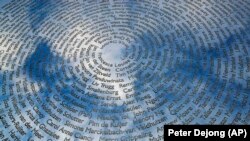 The sky is reflected in the national MH17 monument in Vijfhuizen, the Netherlands, that carries the names of all 298 victims.