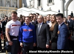 Vladimir Putin (center) poses for a picture with young supporters after his inauguration ceremony in Moscow on May 7.