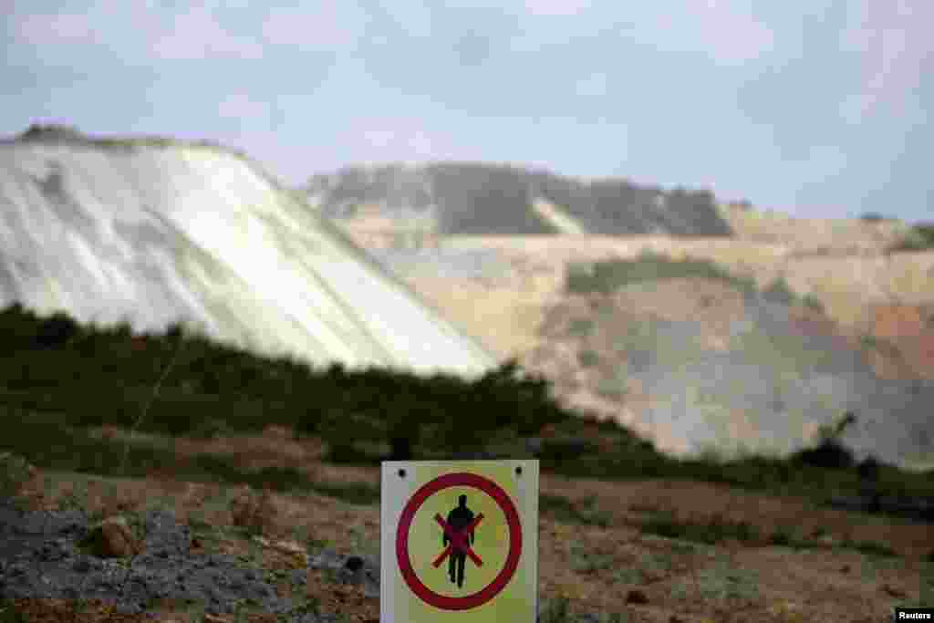 A no-trespassing sign marks the boundary of the open copper pit.