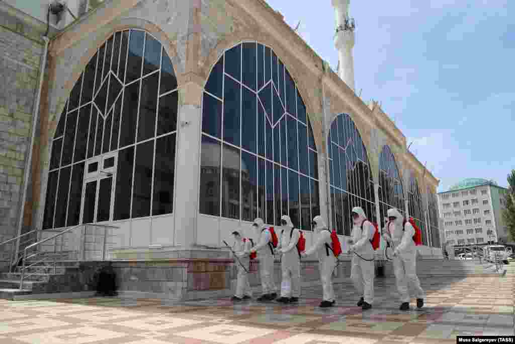 Sanitation crews disinfect the area outside the Djuma Mosque on May 21 in&nbsp;Makhachkala, the capital of the southern Russian region of&nbsp;Daghestan. Authorities have imposed restrictions to deter people from gathering in large groups this weekend, as the mostly Muslim-populated region marks Eid-al-Fitr, known locally as Uraza Bairam.