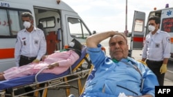 Iranian pilgrims wounded in a stampede in Saudi's Arabia's holy city of Mecca during the annual hajj pilgrimage arrive back in Tehran in September 2015.