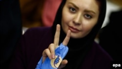 An Iranian supporter of the reformist camp flashes a victory sign during the run-up to national elections elections on February 26. The success of the reformists and relative moderates has given rise to a wave of jokes across Iranian social media. 