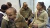 Spain - Several defendants (L) chat in a glass security room at Audiencia Nacional Court's facilities, 31Oct2007